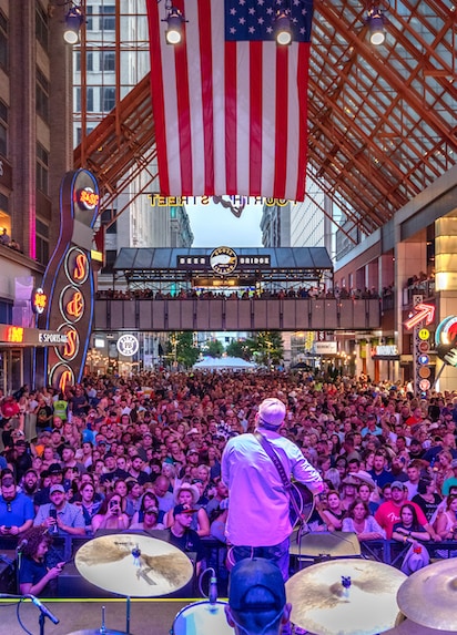 Events: A view from the stage as a band plays to a packed concert crowd. Discover more about Live! events.